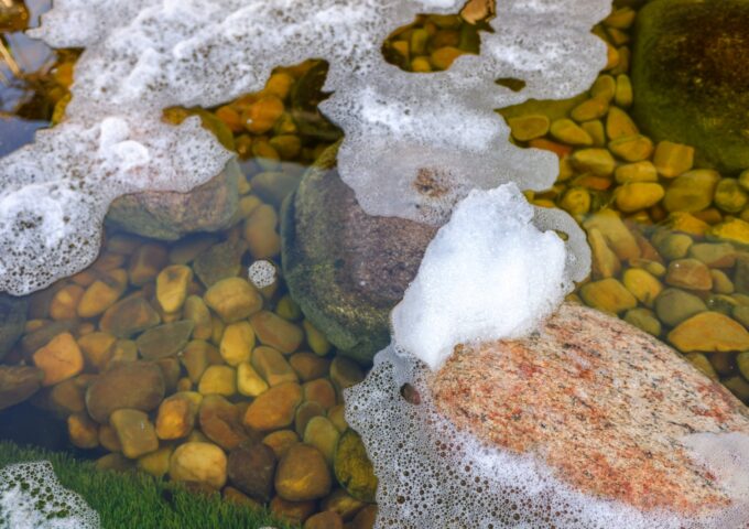 foam contaminates the water and rocks of a river d 2022 05 31 17 22 45 utc